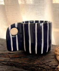 Tuxedo Stoneware Mug Quiet elegance, dressed in detail A glossy black stoneware mug with subtle tonal lines that add depth and structure, designed for a refined and timeless coffee moment.