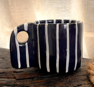 Tuxedo Stoneware Mug Quiet elegance, dressed in detail A glossy black stoneware mug with subtle tonal lines that add depth and structure, designed for a refined and timeless coffee moment.