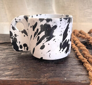 Glazed handmade ceramic mug in earthy tones