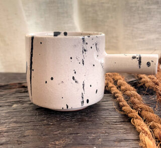 Herba Stoneware Mug Familiar, but reimagined A creamy beige stoneware mug with black speckles, inspired by traditional coffee pots and daily rituals.