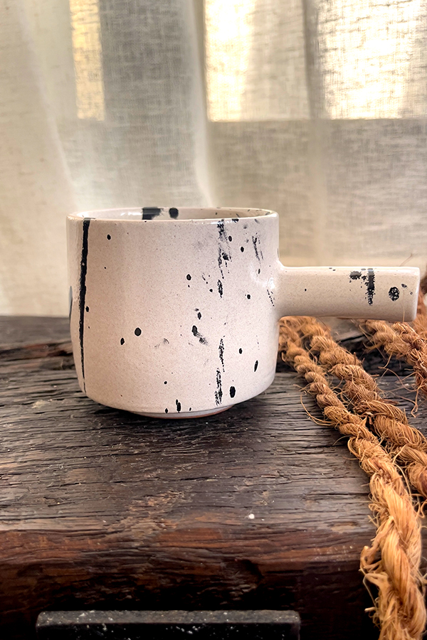 Herba Stoneware Mug Familiar, but reimagined A creamy beige stoneware mug with black speckles, inspired by traditional coffee pots and daily rituals.