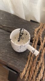 Herba Stoneware Mug Familiar, but reimagined A creamy beige stoneware mug with black speckles, inspired by traditional coffee pots and daily rituals.