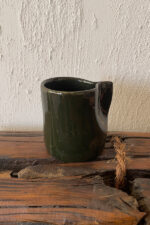 Oliva Stoneware Mug Lighter than it looks. richer than it feels A glossy olive-toned stoneware mug with subtle yellow-green speckles and a flat handle, carrying a fresh, natural energy in every sip.