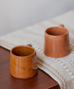 Glazed handmade ceramic mug in earthy tones