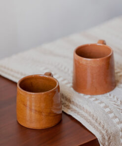 Glazed handmade ceramic mug in earthy tones