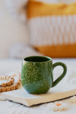 Glazed handmade ceramic mug in earthy tones