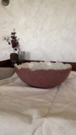 An extra-large stoneware serve bowl with a beautiful cream color and natural dark speckles. It features unique, rough edges for a natural look. With its huge size, it is perfect for serving big family salads, fruits, or hosting guests.