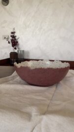 An extra-large stoneware serve bowl with a beautiful cream color and natural dark speckles. It features unique, rough edges for a natural look. With its huge size, it is perfect for serving big family salads, fruits, or hosting guests.