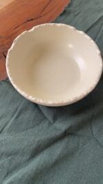 Ivory Serve Bowl A beautiful stoneware serve bowl with a soft creamy white color. It features unique, rough edges for a natural touch. With its perfect size, it is great for serving salads, hot soups, or daily dishes.