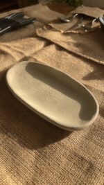 Suna Organic Platter Handcrafted from premium natural stoneware, this Wabi-Sabi platter features a unique sandy texture and organic edges—perfectly sized to serve your finest appetizers or style your favorite home accents.