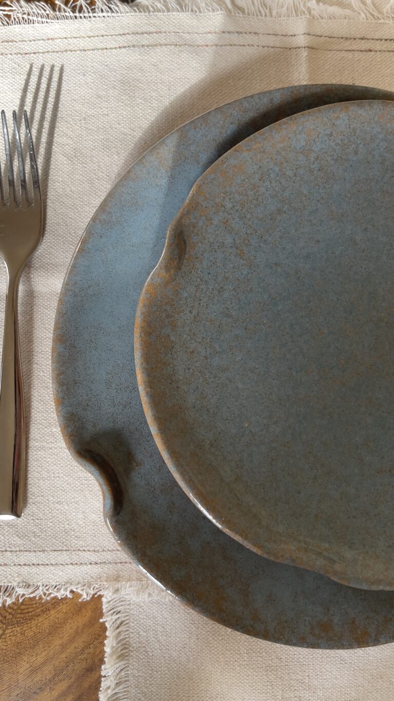 Remnant Dinnerware Plate Inspired by the quiet traces of nature, this organic stoneware plate features unique speckled textures and artfully distorted rims. The calming harmony of sky blue and rock grey makes the Remnant set less of a dinnerware and more of a sculpted art piece for your dining space.