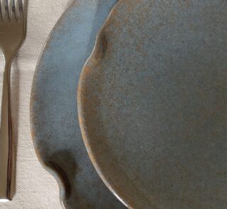 Remnant Dinnerware Plate Inspired by the quiet traces of nature, this organic stoneware plate features unique speckled textures and artfully distorted rims. The calming harmony of sky blue and rock grey makes the Remnant set less of a dinnerware and more of a sculpted art piece for your dining space.