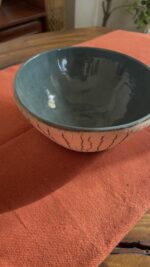 Arc Emerald Bowl Crafted with a textured, crackled exterior and a vibrant emerald green glaze inside, this compact bowl adds a striking touch to your table. It is perfect for individual snacks or dips.
