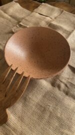 Conical Serve Bowl A large and beautiful stoneware serve bowl with a warm sandy color and natural dark speckles. With its wide shape, it is perfect for serving big family salads, fruits, or main dishes.