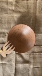 Conical Serve Bowl A large and beautiful stoneware serve bowl with a warm sandy color and natural dark speckles. With its wide shape, it is perfect for serving big family salads, fruits, or main dishes.