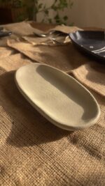 Suna Organic Platter Handcrafted from premium natural stoneware, this Wabi-Sabi platter features a unique sandy texture and organic edges—perfectly sized to serve your finest appetizers or style your favorite home accents.