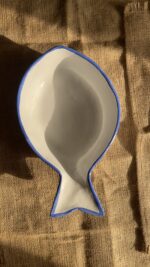 Caspian Fish Bowl Enjoy your seafood in a refreshing, open-air seaside vibe. Featuring a clean white base and a vibrant blue hand-painted rim, this fish-shaped individual bowl is perfect for your personal servings of seafood soup or pasta.