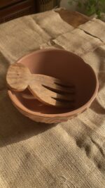 Canyon Serve Bowl A unique stoneware bowl with a beautiful carved design on the outside. It comes in a warm, natural brown clay color. With its deep shape, it is perfect for serving salads, fruits, or hot dishes.