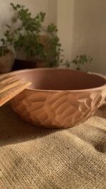 Canyon Serve Bowl A unique stoneware bowl with a beautiful carved design on the outside. It comes in a warm, natural brown clay color. With its deep shape, it is perfect for serving salads, fruits, or hot dishes.