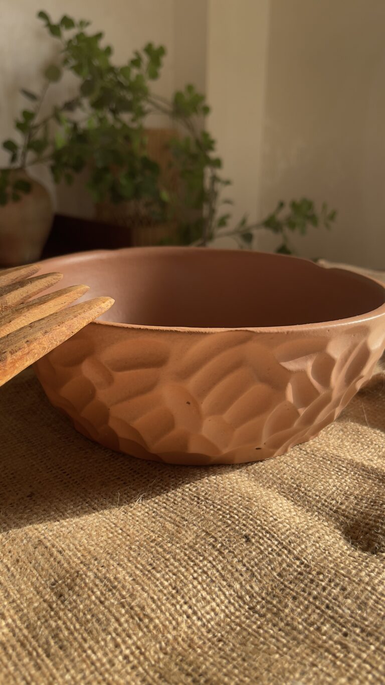 Canyon Serve Bowl A unique stoneware bowl with a beautiful carved design on the outside. It comes in a warm, natural brown clay color. With its deep shape, it is perfect for serving salads, fruits, or hot dishes.