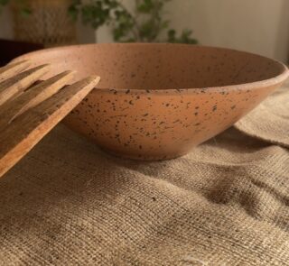 Conical Serve Bowl A large and beautiful stoneware serve bowl with a warm sandy color and natural dark speckles. With its wide shape, it is perfect for serving big family salads, fruits, or main dishes.