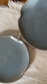 Remnant Dinnerware Plate Inspired by the quiet traces of nature, this organic stoneware plate features unique speckled textures and artfully distorted rims. The calming harmony of sky blue and rock grey makes the Remnant set less of a dinnerware and more of a sculpted art piece for your dining space.