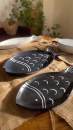 Ocean Fish Dinnerware Set A unique fish-shaped stoneware dinnerware collection in a rich dark blue color with charming hand-painted white details. It adds a modern, sea-inspired touch to your dining table.