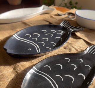 Ocean Fish Dinnerware Set A unique fish-shaped stoneware dinnerware collection in a rich dark blue color with charming hand-painted white details. It adds a modern, sea-inspired touch to your dining table.