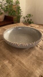 Crafted from a unique mix of natural bamboo and durable stoneware, this eye-catching serving platter stands out with its artfully detailed stitched borders. Ideal for both styling your home and serving snacks, it seamlessly adds an authentic, earthy vibe to your space.