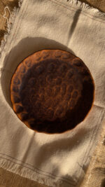 Bark Side Plate A beautiful stoneware side plate with a shiny mix of brown and honey colors. Handcrafted with a natural round shape, it is perfect for serving your daily sides, desserts, or small snacks.