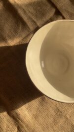 Flugor Pearl Bowl Crafted with a textured, crackled exterior and a vibrant alabaster beige glaze inside, this compact bowl adds a striking touch to your table. It is perfect for individual snacks or dips.