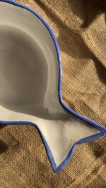 Caspian Fish Bowl Enjoy your seafood in a refreshing, open-air seaside vibe. Featuring a clean white base and a vibrant blue hand-painted rim, this fish-shaped individual bowl is perfect for your personal servings of seafood soup or pasta.