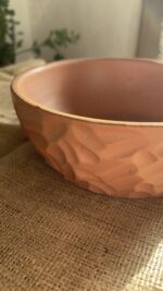 Canyon Serve Bowl A unique stoneware bowl with a beautiful carved design on the outside. It comes in a warm, natural brown clay color. With its deep shape, it is perfect for serving salads, fruits, or hot dishes.