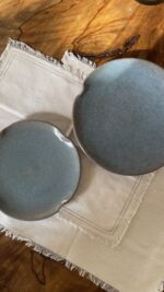 Remnant Dinnerware Plate Inspired by the quiet traces of nature, this organic stoneware plate features unique speckled textures and artfully distorted rims. The calming harmony of sky blue and rock grey makes the Remnant set less of a dinnerware and more of a sculpted art piece for your dining space.