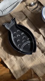 Ocean Fish Dinnerware Set A unique fish-shaped stoneware dinnerware collection in a rich dark blue color with charming hand-painted white details. It adds a modern, sea-inspired touch to your dining table.