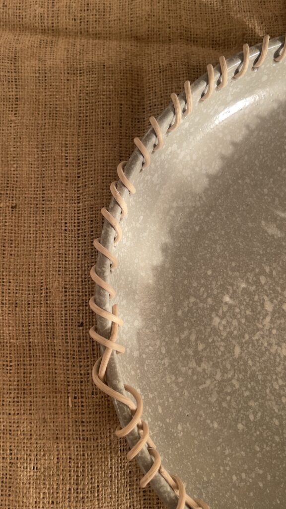 Crafted from a unique mix of natural bamboo and durable stoneware, this eye-catching serving platter stands out with its artfully detailed stitched borders. Ideal for both styling your home and serving snacks, it seamlessly adds an authentic, earthy vibe to your space.