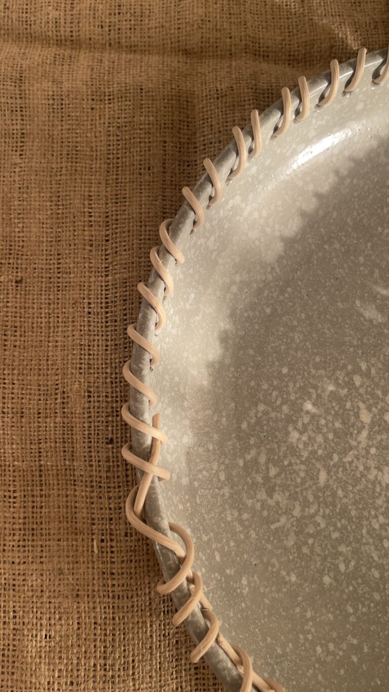 Crafted from a unique mix of natural bamboo and durable stoneware, this eye-catching serving platter stands out with its artfully detailed stitched borders. Ideal for both styling your home and serving snacks, it seamlessly adds an authentic, earthy vibe to your space.