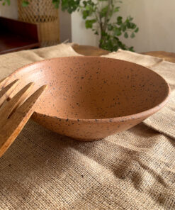 Conical Serve Bowl A large and beautiful stoneware serve bowl with a warm sandy color and natural dark speckles. With its wide shape, it is perfect for serving big family salads, fruits, or main dishes.