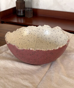 An extra-large stoneware serve bowl with a beautiful cream color and natural dark speckles. It features unique, rough edges for a natural look. With its huge size, it is perfect for serving big family salads, fruits, or hosting guests.
