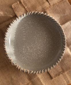 Crafted from a unique mix of natural bamboo and durable stoneware, this eye-catching serving platter stands out with its artfully detailed stitched borders. Ideal for both styling your home and serving snacks, it seamlessly adds an authentic, earthy vibe to your space.