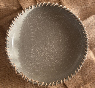 Crafted from a unique mix of natural bamboo and durable stoneware, this eye-catching serving platter stands out with its artfully detailed stitched borders. Ideal for both styling your home and serving snacks, it seamlessly adds an authentic, earthy vibe to your space.