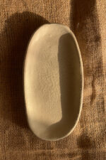 Suna Organic Platter Handcrafted from premium natural stoneware, this Wabi-Sabi platter features a unique sandy texture and organic edges—perfectly sized to serve your finest appetizers or style your favorite home accents.
