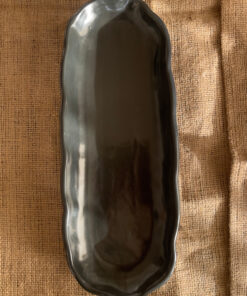 Mori Sharing Platter Captivating with its rich burgundy glaze and gently scalloped rim, this expansive stoneware platter brings a touch of dramatic warmth to your table. Its low, sleek profile makes it an exquisite backdrop for artistic food presentation or a striking accent piece for grand hosting.