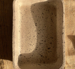 Pebble Oven Dish A beautiful rectangular stoneware dish with a warm sandy color and natural dark speckles. Perfect for both baking in the oven and serving directly on the table. It is great for making family meals, pasta, or roasted dishes.