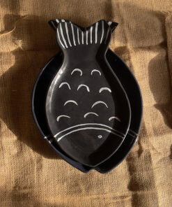 Ocean Fish Dinnerware Set A unique fish-shaped stoneware dinnerware collection in a rich dark blue color with charming hand-painted white details. It adds a modern, sea-inspired touch to your dining table.