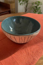Arc Emerald Bowl Crafted with a textured, crackled exterior and a vibrant emerald green glaze inside, this compact bowl adds a striking touch to your table. It is perfect for individual snacks or dips.
