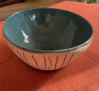 Arc Emerald Bowl Crafted with a textured, crackled exterior and a vibrant emerald green glaze inside, this compact bowl adds a striking touch to your table. It is perfect for individual snacks or dips.