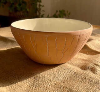 Flugor Pearl Bowl Crafted with a textured, crackled exterior and a vibrant alabaster beige glaze inside, this compact bowl adds a striking touch to your table. It is perfect for individual snacks or dips.