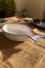 Caspian Fish Bowl Enjoy your seafood in a refreshing, open-air seaside vibe. Featuring a clean white base and a vibrant blue hand-painted rim, this fish-shaped individual bowl is perfect for your personal servings of seafood soup or pasta.