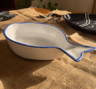 Caspian Fish Bowl Enjoy your seafood in a refreshing, open-air seaside vibe. Featuring a clean white base and a vibrant blue hand-painted rim, this fish-shaped individual bowl is perfect for your personal servings of seafood soup or pasta.
